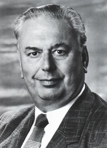 Man wearing a checkered suit and patterned tie.