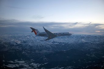 Research airplane over a mountain range.