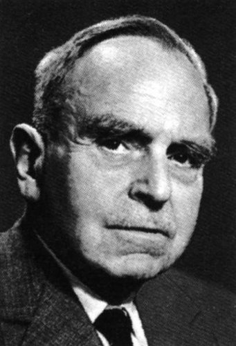 Otto Hahn (1879-1968). Quelle: MPG Archiv Berlin-Dahlem Ein Mann in einem Anzug, schwarz-weiß, vor dunklem Hintergrund.