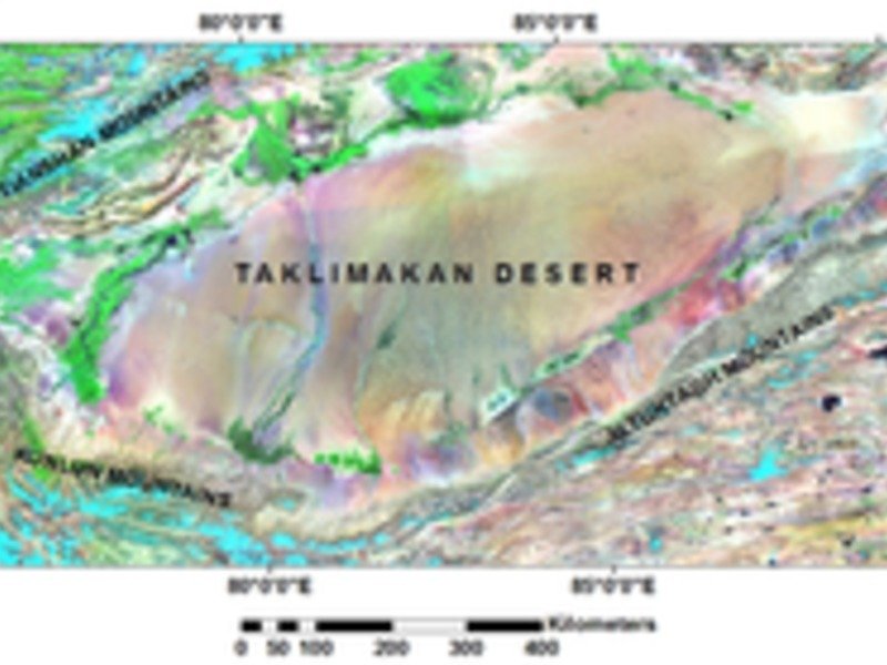 Satellite picture (Landsat) of the Taklamakan desert. The big brown area shows the desert, the green areas show the vegetation of the surrounding the oases and the blue areas in the mountains are snow.