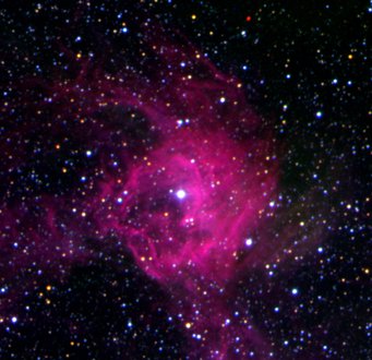 Stardust in meteorites is older than our solar system and originates from the winds and ejected matter from stars that have long since died. A luminous star is enveloped in a pink nebula amidst a dense field of stars.