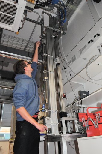 Person works on measurement instrument.