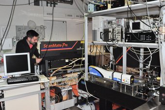 Person works on measurement instrument.