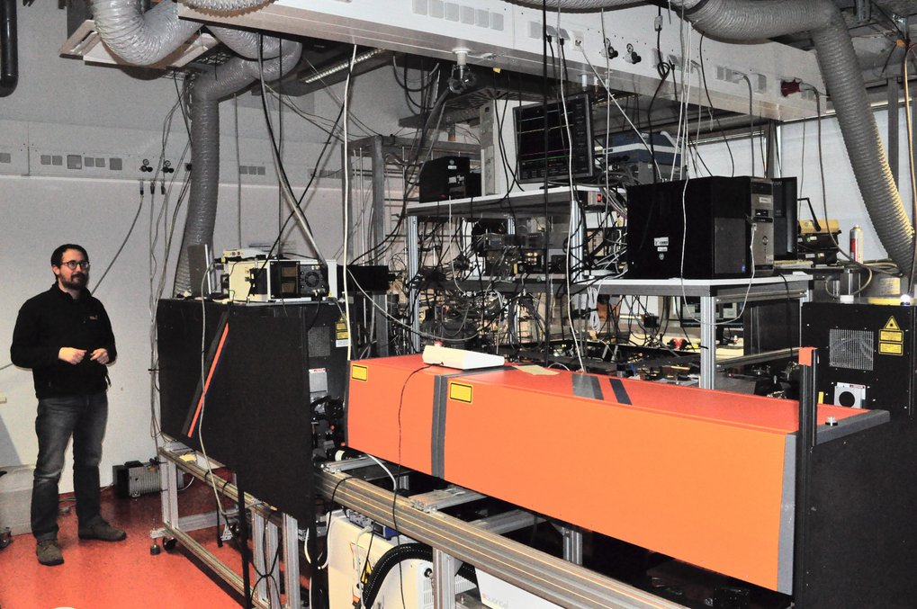 Person standing next to measurement instruments in a lab.