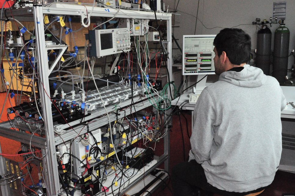 Person works on measurement instrument.