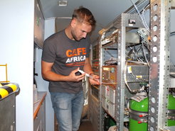 Person working on instruments in an airplane during a campaign.