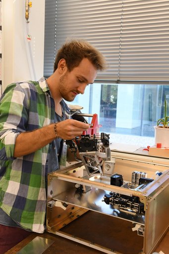 Person working on instruments in a lab.