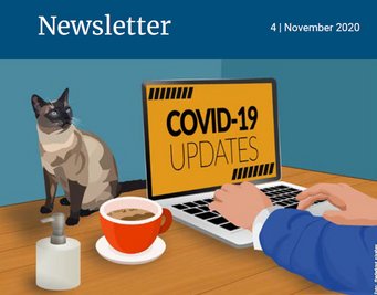 Laptop displaying "COVID-19 Updates" beside a cat and coffee.
