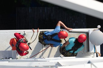 Scientists check a measuring device installed on one of the tower's lower platforms. Scientists checking a measuring device installed on one of the tower's lower platforms. Picture taken from above.