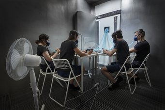 Not visible, but measurable: an oxidation field is generated around each person in the stainless steel climate chamber at the Technical University of Denmark. people sitting around a table