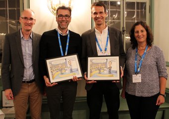 ACP co-chief executive editors Ken Carslaw and Barbara Ervens (left, right) with Thomas Koop and Uli Pöschl (center left, center right) who received a cartoon commemorating intense discussions at the first ACP editorial board meeting. ACP co-chief executive editors Ken Carslaw and Barbara Ervens (left, right) with Thomas Koop and Uli Pöschl (center left, center right).