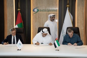 Jos Lelieveld (Managing Director at MPI for Chemistry, Mainz), left, Ahmed Baharoon (Executive Director of Environment Information, Science Outreach Management Sector at Environment Agency - Abu Dhabi), center, and Jean Sciare (Director, Climate and Atmosphere Research Center, The Cyprus Institute Cyprus Institute, Nicosia) sign the Memorandum of Understanding for cooperation in the large-scale research expedition AREAD (Atmospheric Research Expedition to Abu Dhabi). Three officials seated at a conference table sign documents, with UAE flags and Environment Agency Abu Dhabi logo prominently displayed behind them.