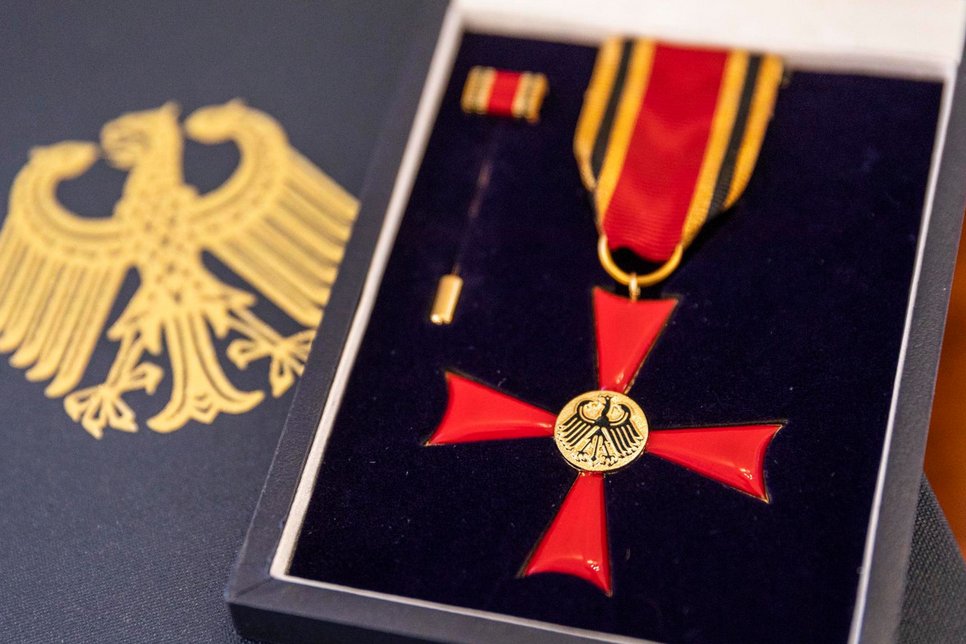 Picture of the Cross of Merit of the Federal Republic of Germany. In exceptional cases, the Cross of Merit of the Federal Republic of Germany is awarded personally by the Federal President, for example on the occasion of German Unity Day.