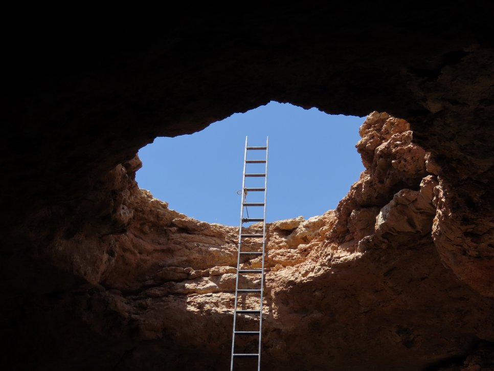 Descend into the depths: the entrance to a cave in the Arabian Desert.