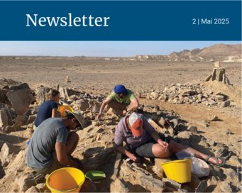 Archaeologists working in a desert excavation site.