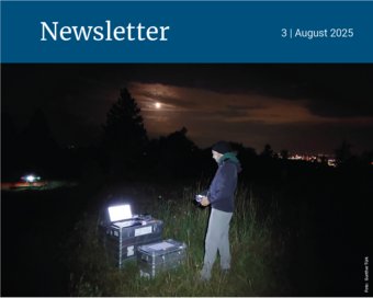 Person in field with laptop and equipment at night.
