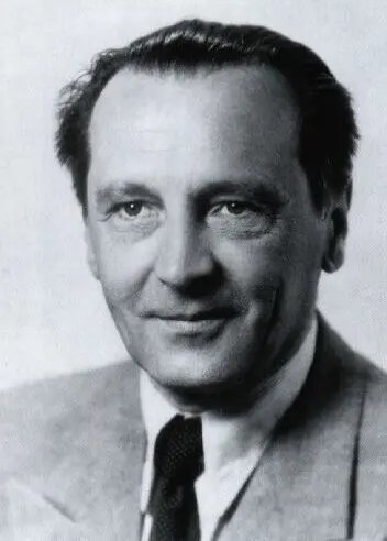 Black and white portrait of a man in a suit and tie.